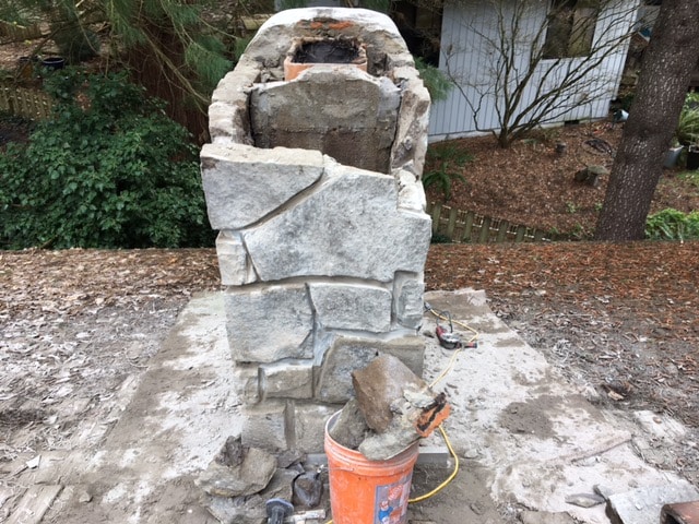 Rebuilding a stone chimney.
